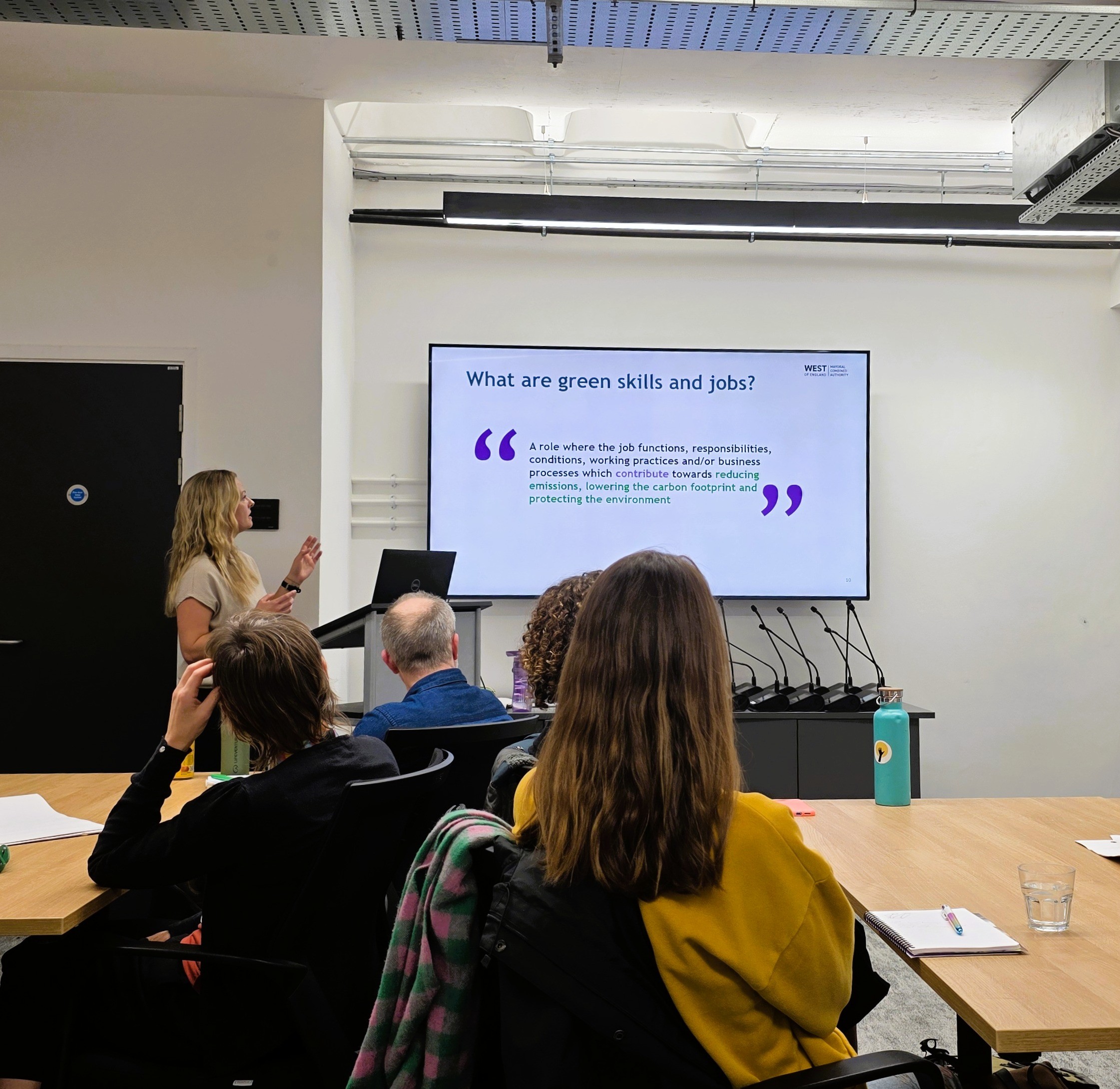 Person leading a skills presentation with text on a big screen