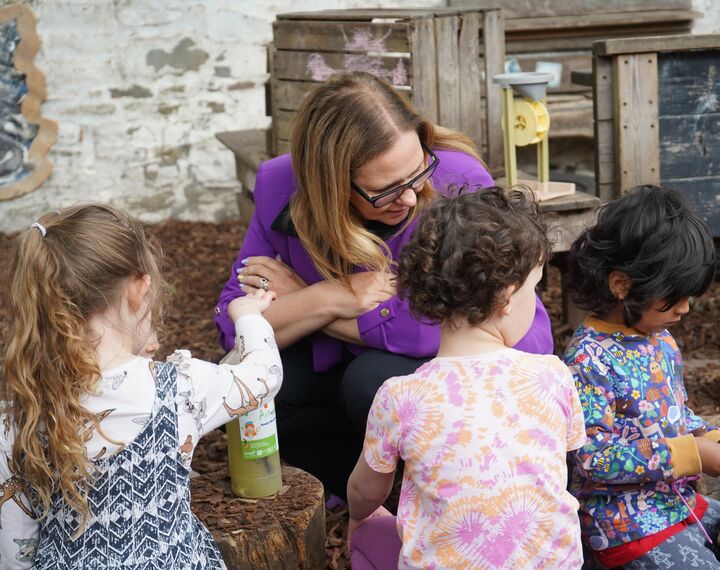 mayor helen godwin talks to young children playing outside