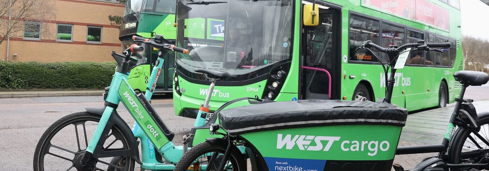 Buses, scooters, bikes, and cargo bikes are pictured at a WESTbusStop+