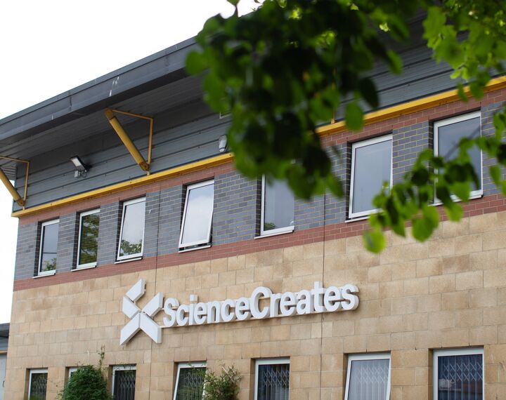 building with sign saying 'Science Creates'