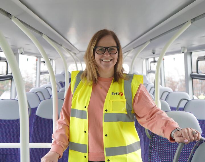 Mayor Helen Godwin on the top deck of a bus, wearing a first bus high-vis