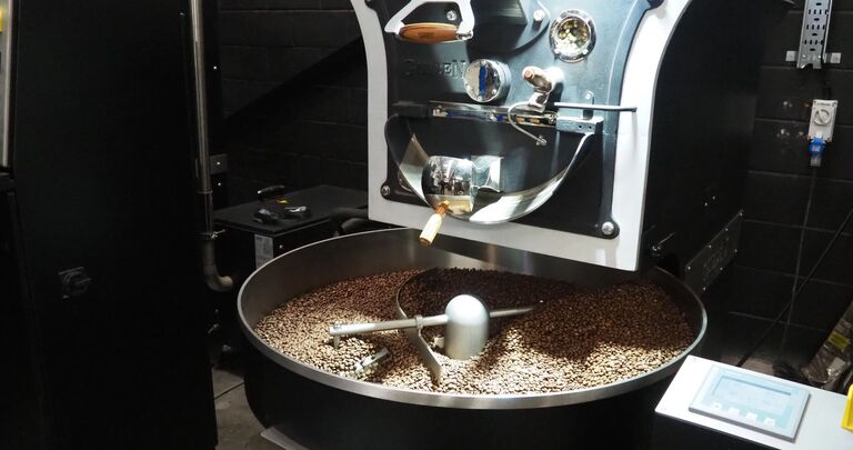 coffee beans in a black and silver machine