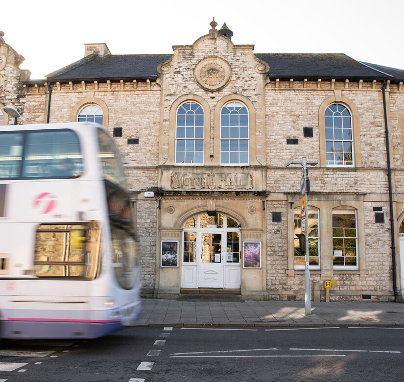 Bus passing in front of Victoria Hall museum in Radstock