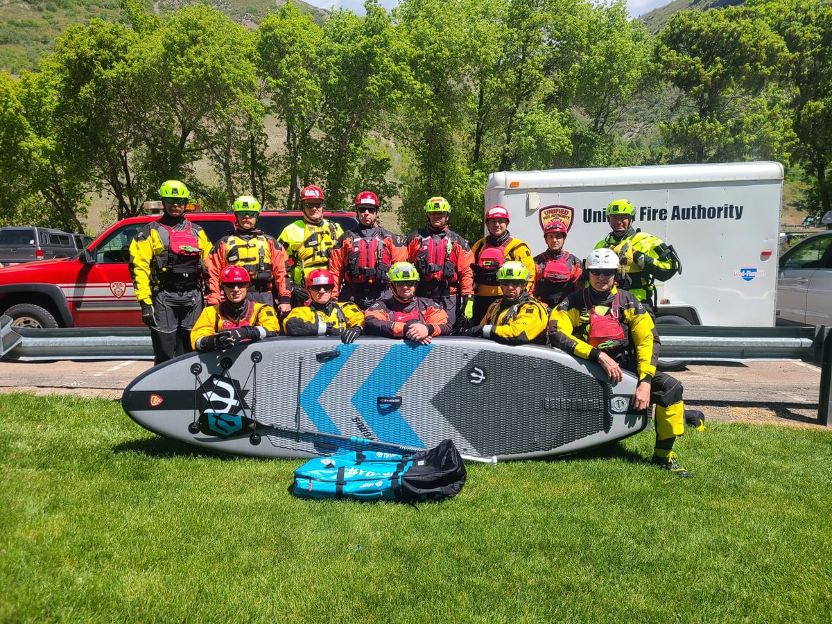 rescue team standing behind hydrus paddleboard