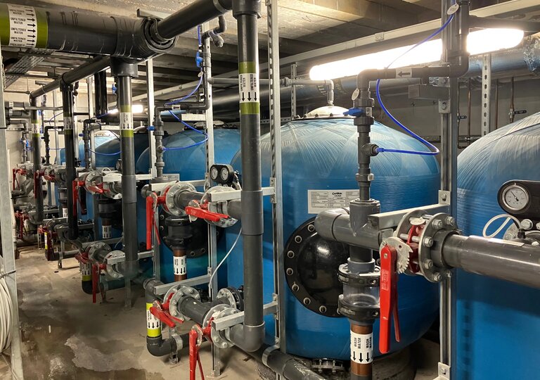 plant room located uphill from the pool to protect equipment from flooding