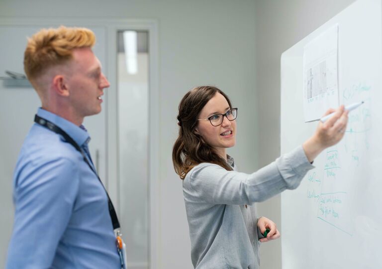 Teacher speaking in front of screen
