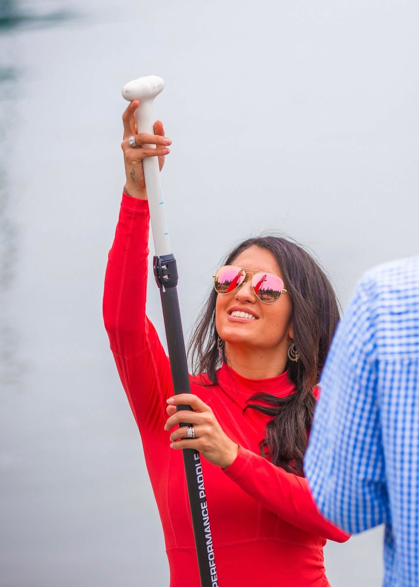 woman adjusting a 3pc paddle to height