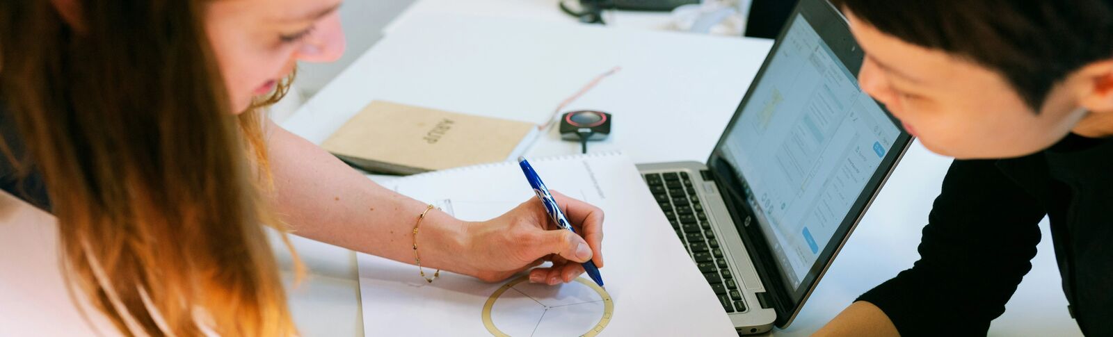 Two young people working on a diagram