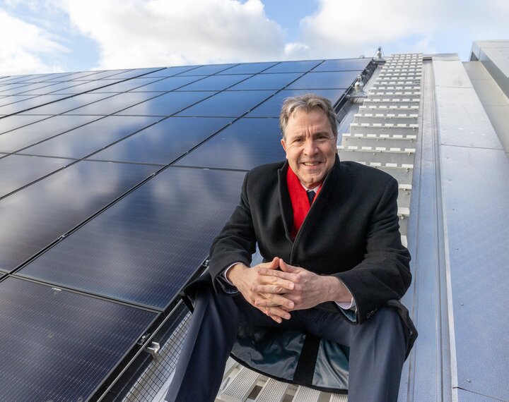 Mayor Dan Norris sitting by the solar panels