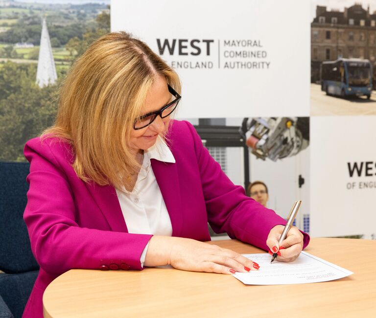 Helen signing paperwork