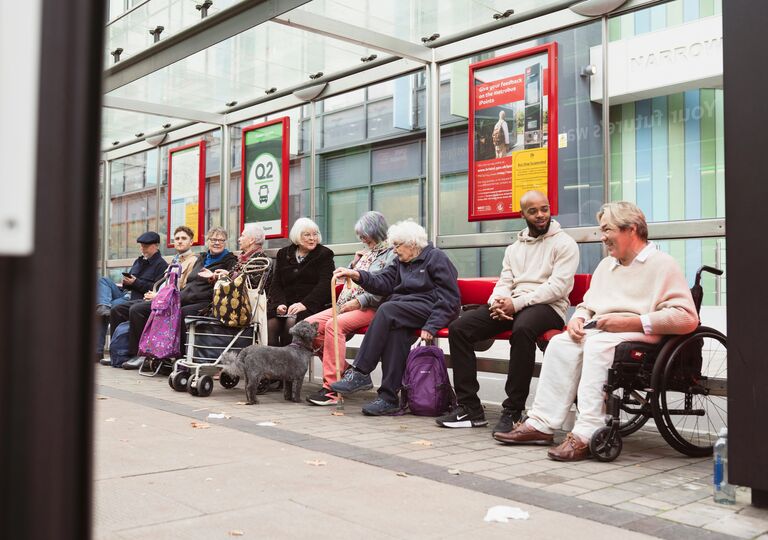 people sitting at a bus stop