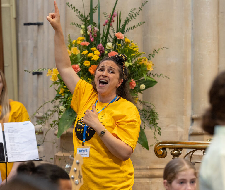 Singer pointing to the ceiling mid-song