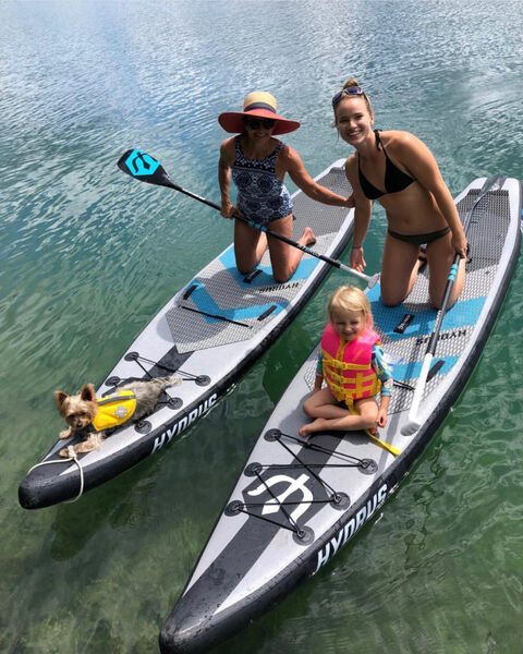 Family smiling on Hydrus paddle boards