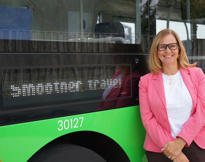 Mayor Helen Godwin in front of green WEST bus