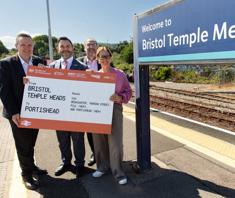 Helen and UA leaders holding an oversized train ticket