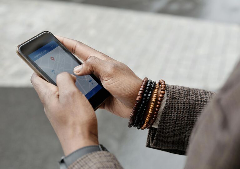 close up of hands holding a phone with a map on it