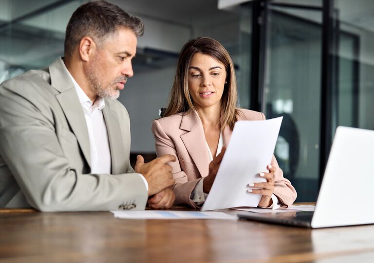 man and woman looking at paperwork