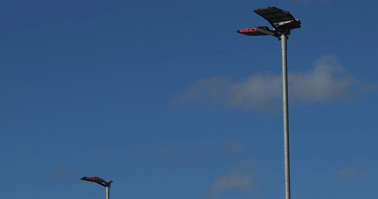 close up of floodlights against blue sky background