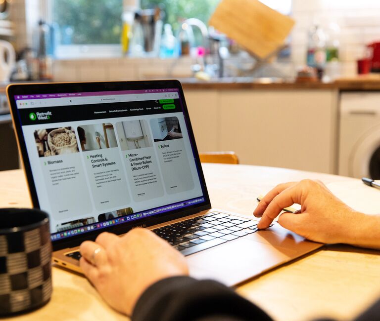 Person accessing retrofit west website on a laptop