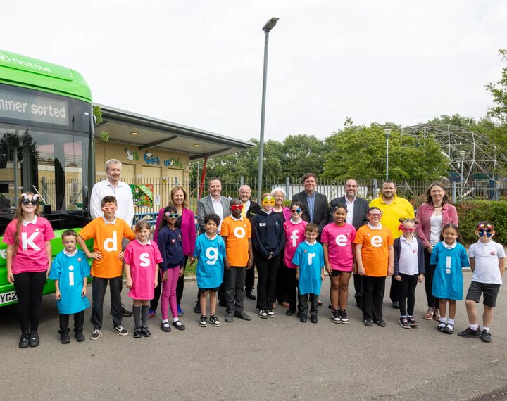 Helen Godwin, the new Mayor of the West of England, is pictured with council leaders, bus operators, a bus, and play park - with children wearing t-shirts spelling out 