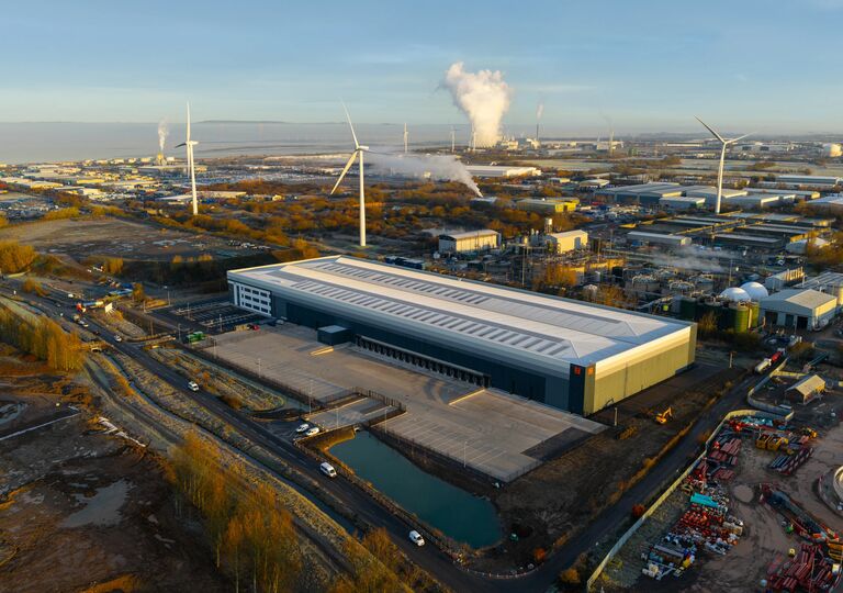 aerial view of indurent park with water and wind turbines