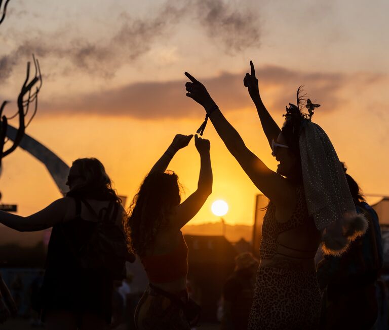 People dancing at sunset