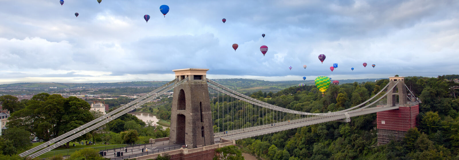 hot air balloons in the sky above clifton suspension bridge