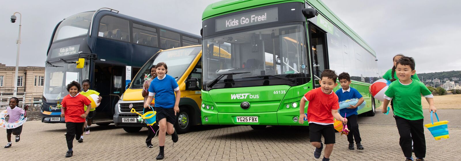 Children are pictured in front of buses that read: Kids Go Free!