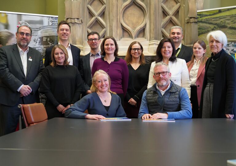 members of the Business Board gather round a table