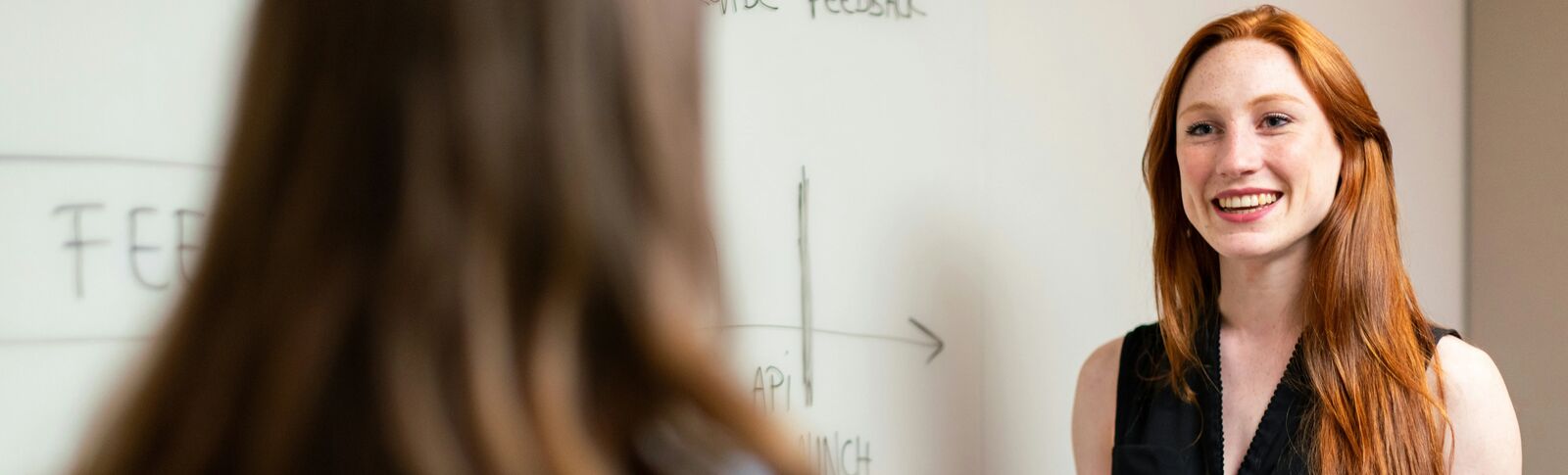 Smiling person at whiteboard