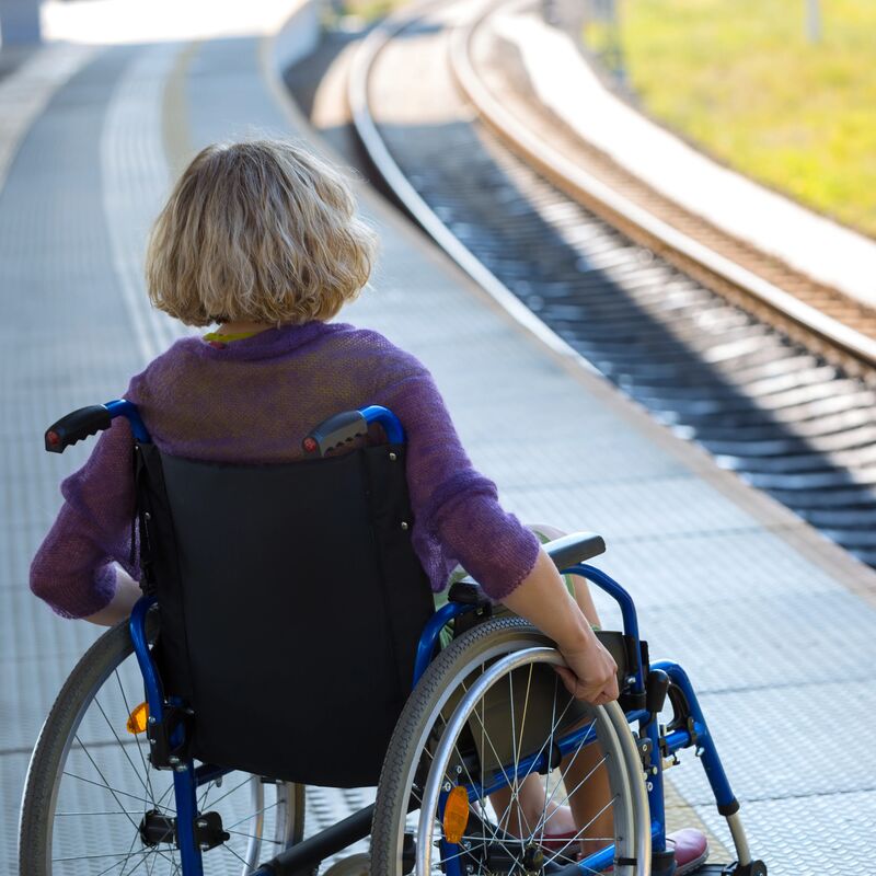 person using a wheelchair on a train platform