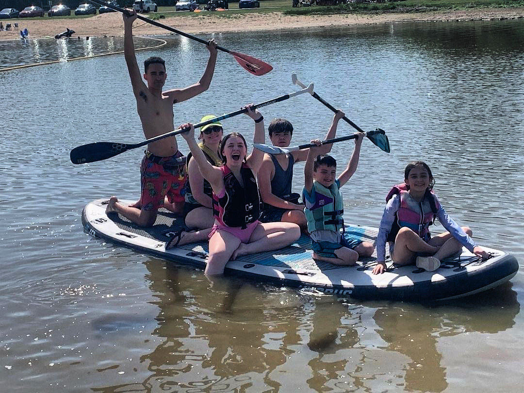 Family on a large paddle board