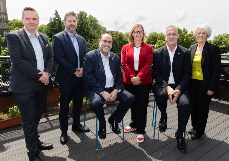 Mayor and council leaders standing in a row, smiling at the camera