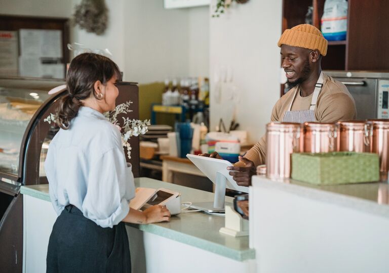 a person serving someone in a cafe