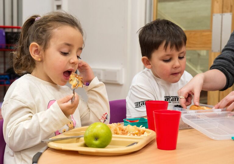 two small children eating food