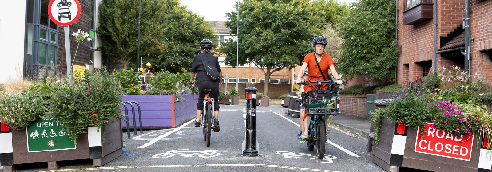 two people cycling in opposite directions
