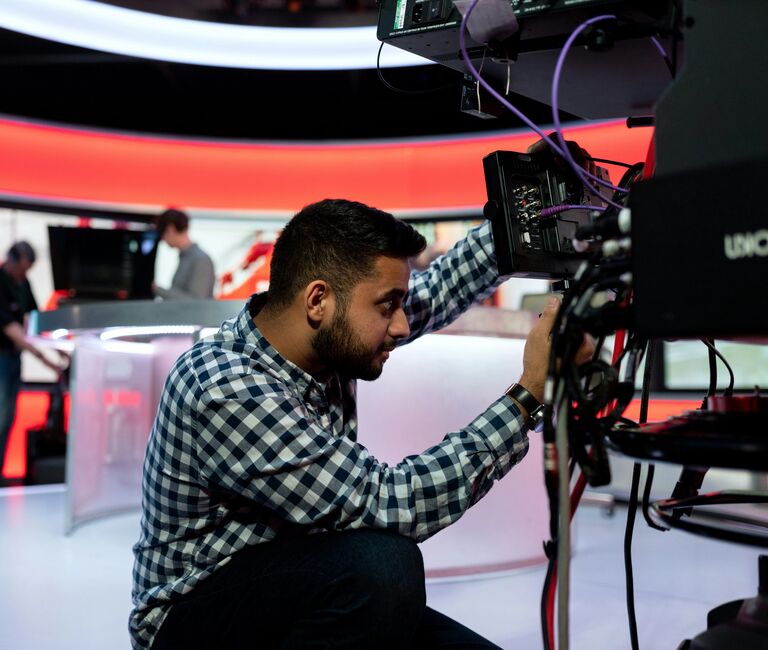Person working on tv equipment