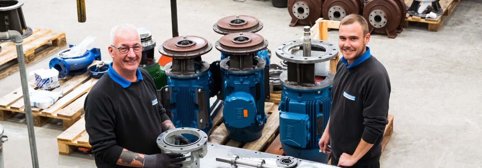 Two people working on a pump