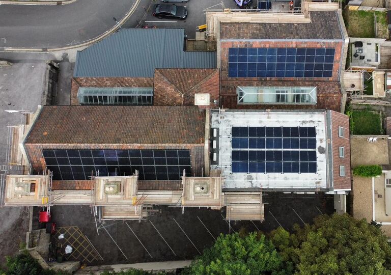 aerial view of building with solar panels installed