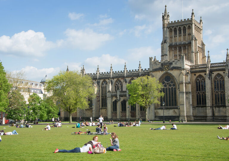 College green with people lying around