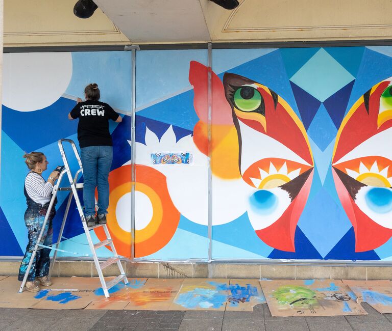 two people working on street art