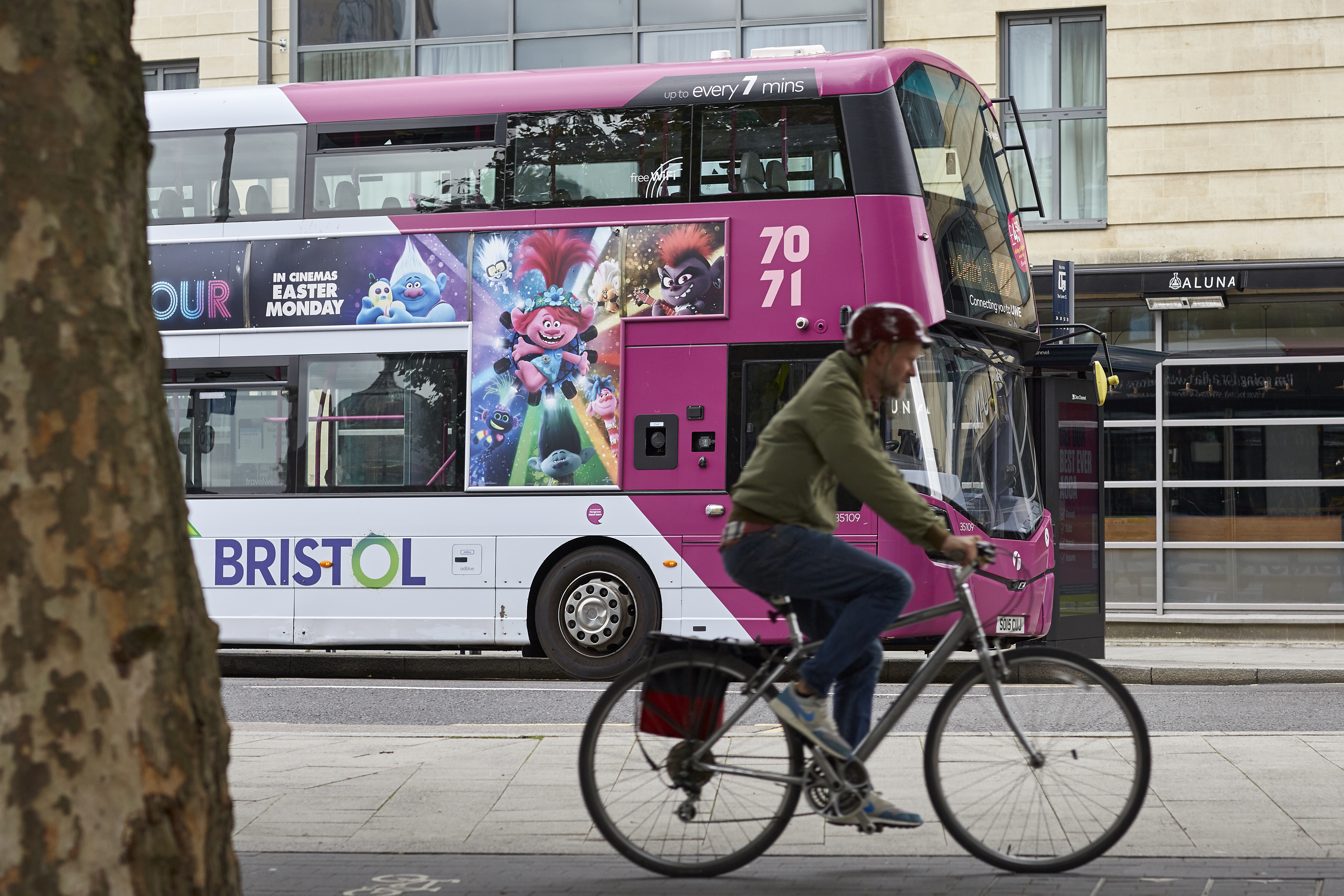 Man cycling by bus
