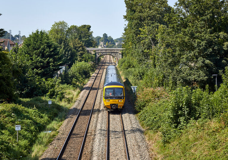 Train on track, bridge in background