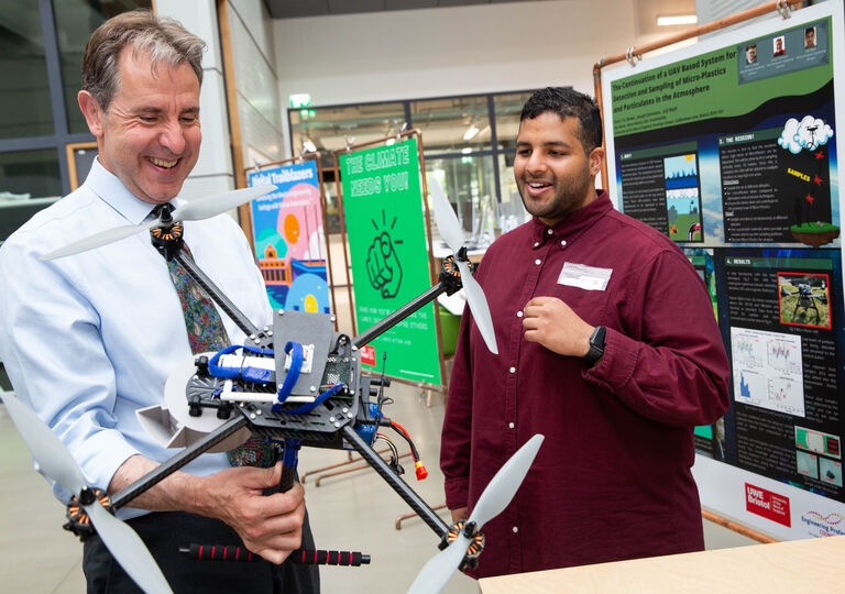 Metro Mayor Dan Norris holding a drone that can measure microplastics in the air built by award-winning student Ewan Brown