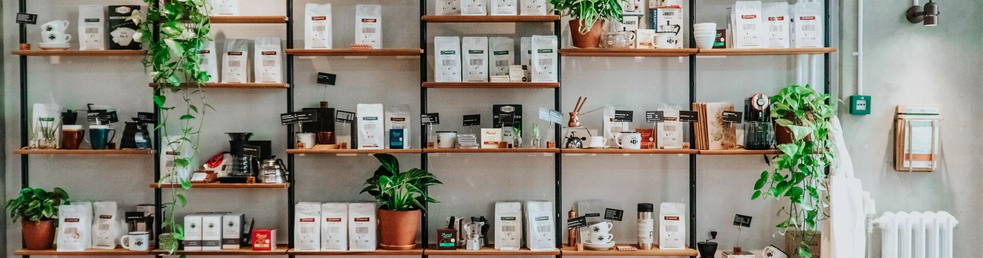 Shelves with coffee bags and plants