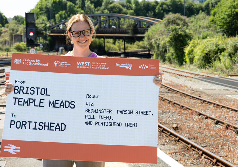 Mayor holding oversized train ticket