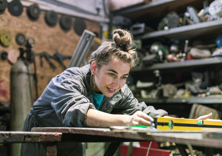 young person working on a tool bench