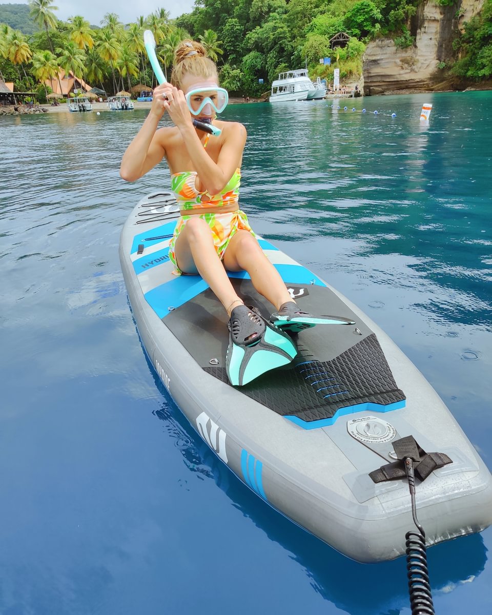 woman snorkeling on hydrus paddleboard in tropical location
