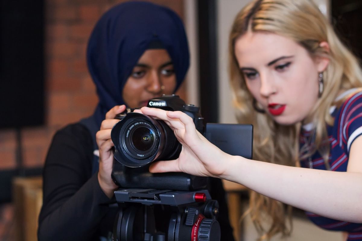 Photography students at a camera