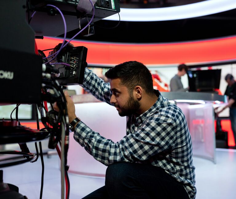 Apprentice working on camera equipment